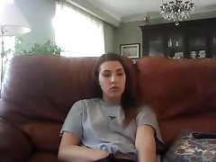 Horny girl is rubbing her pussy in the living room, while watching a porn movie