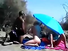 Horny people are having casual sex on the beach, not knowing that someone is watching them