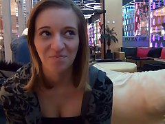 Slutty babe with blonde hair is kneeling in a public place and sucking a stranger's dick