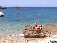 Lustful Mia Magma is gently sucking her friend's rock hard dick on a beautiful beach