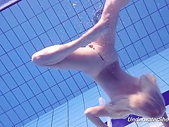 Lovely blonde babe took off all of her clothes and jumped into the swimming pool