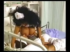 Hot nurse with curly hair and big tits is fucking her patient in the hospital