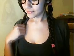 Long haired German brunette with huge black glasses is fingering her pussy in front of the camera